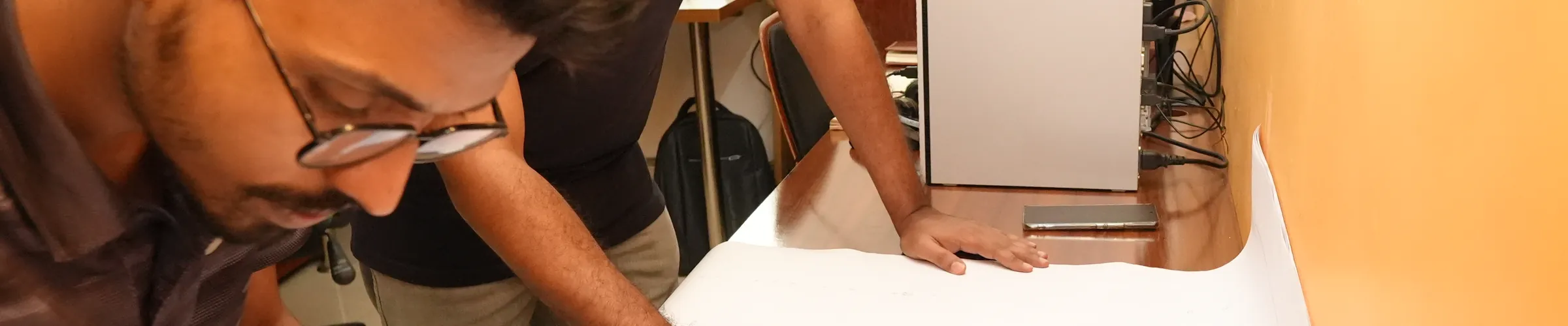 A Zesterex engineer checking a marked-up drawing set