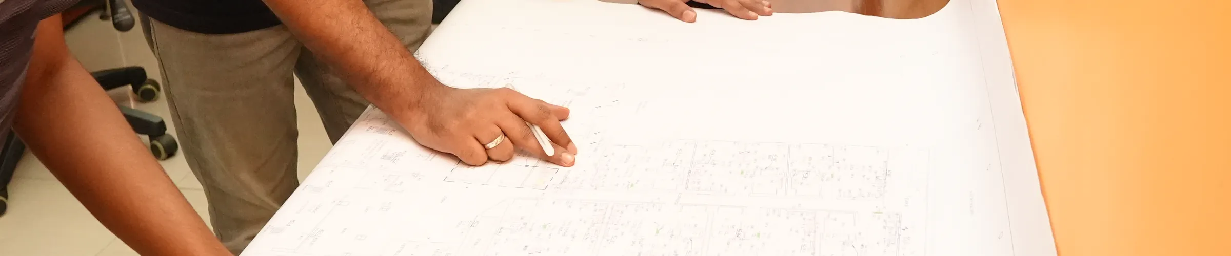 A marked-up services drawing on the studio table