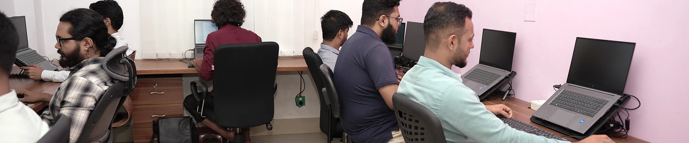 Zesterex engineers working at their desks in the team room