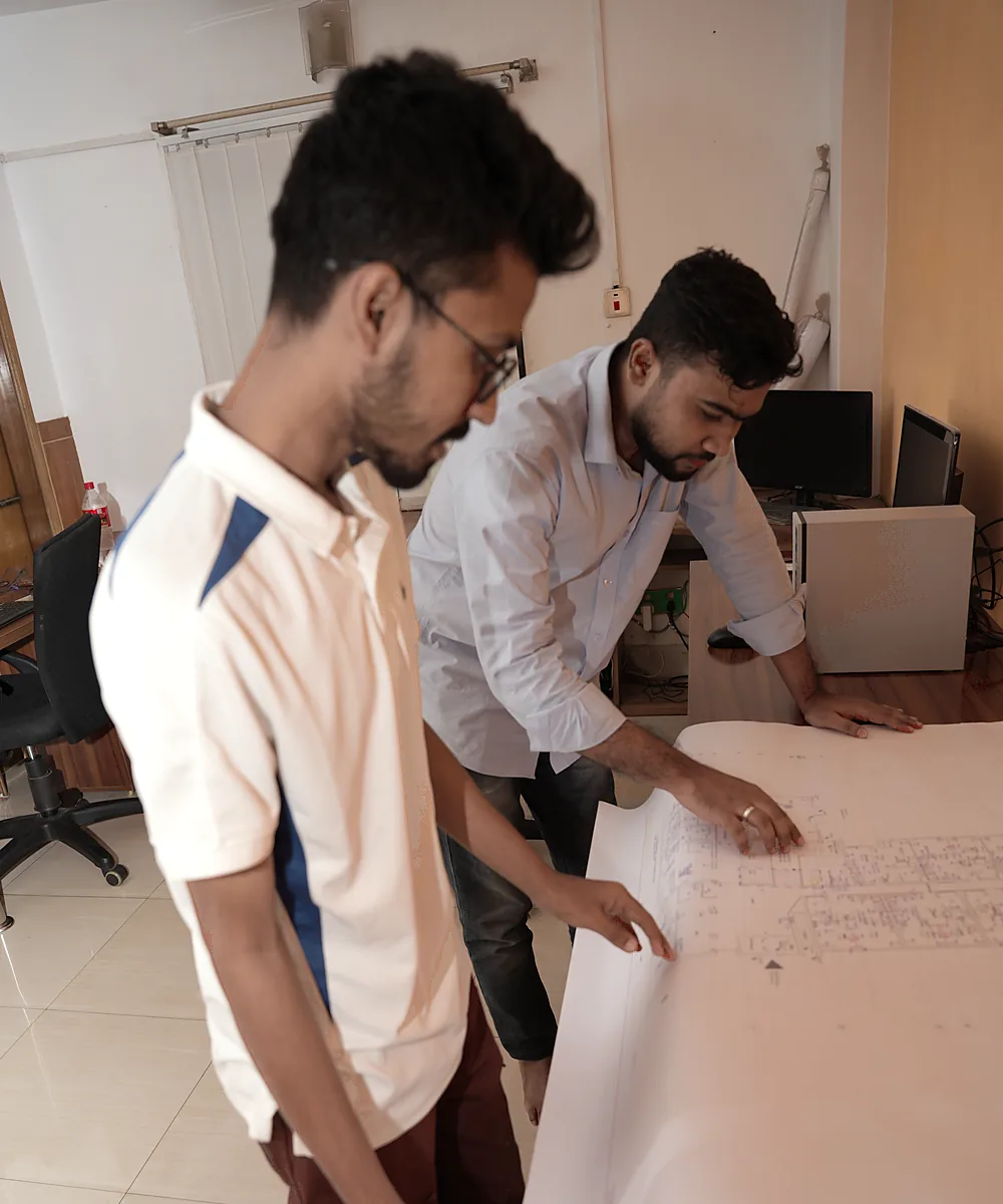 Engineers reviewing a printed plan at the layout table