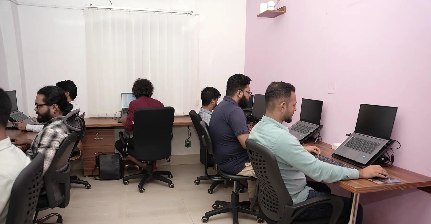 Zesterex engineers working at their desks in the team room