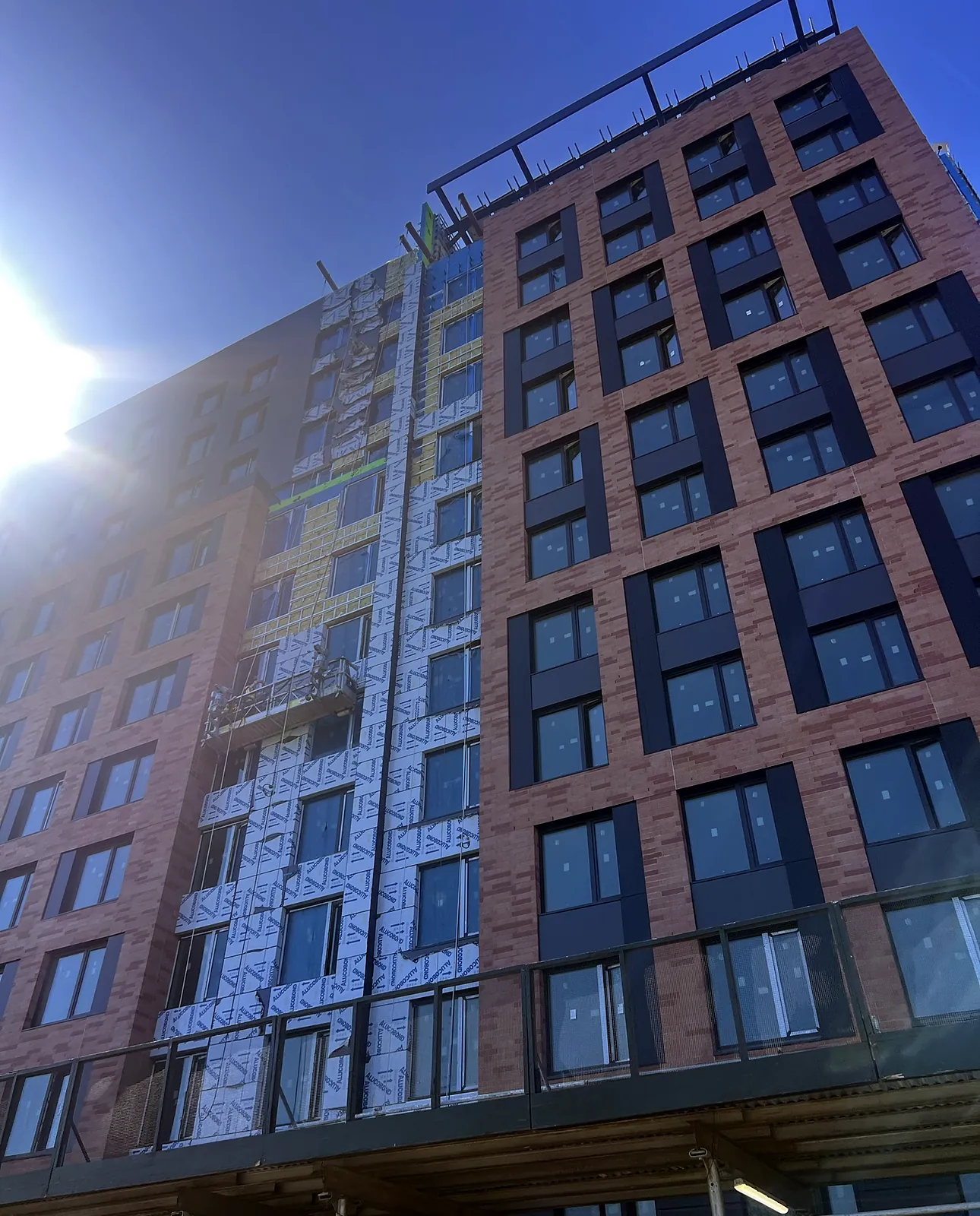 Brick and panel facade of a multifamily building
