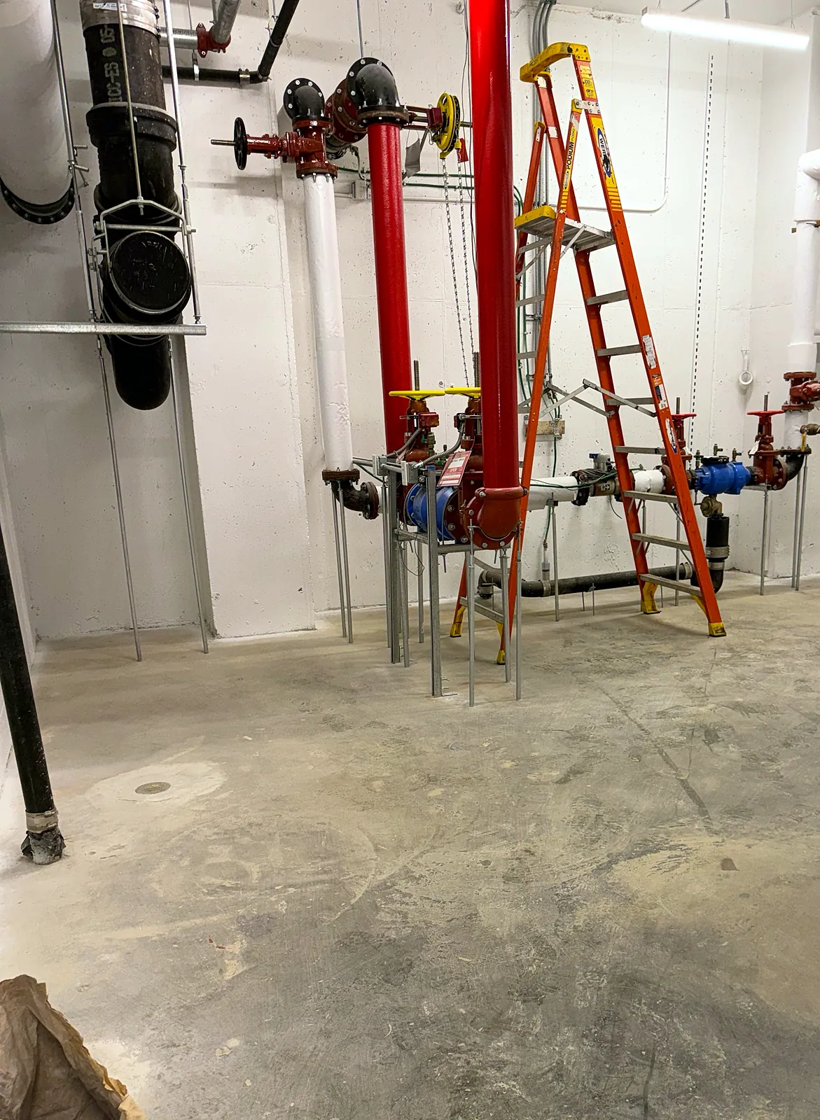 Fire sprinkler riser and valves in a service room