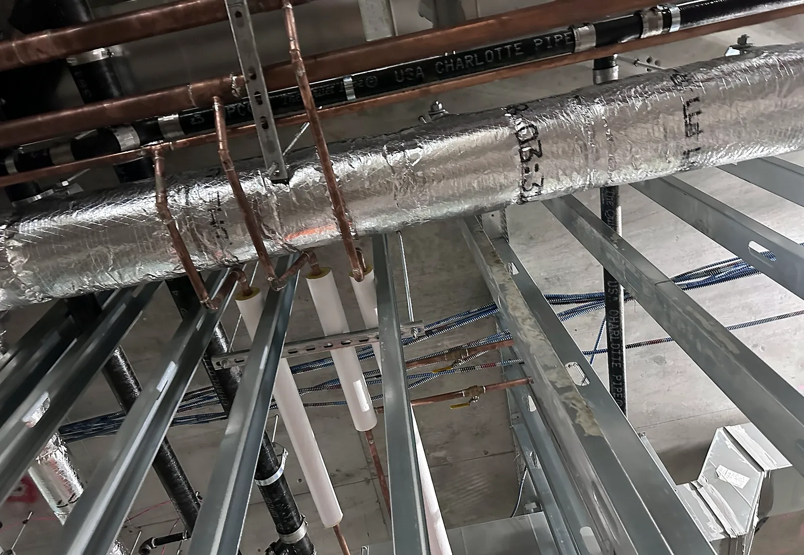 Insulated pipework running through light-gauge steel framing