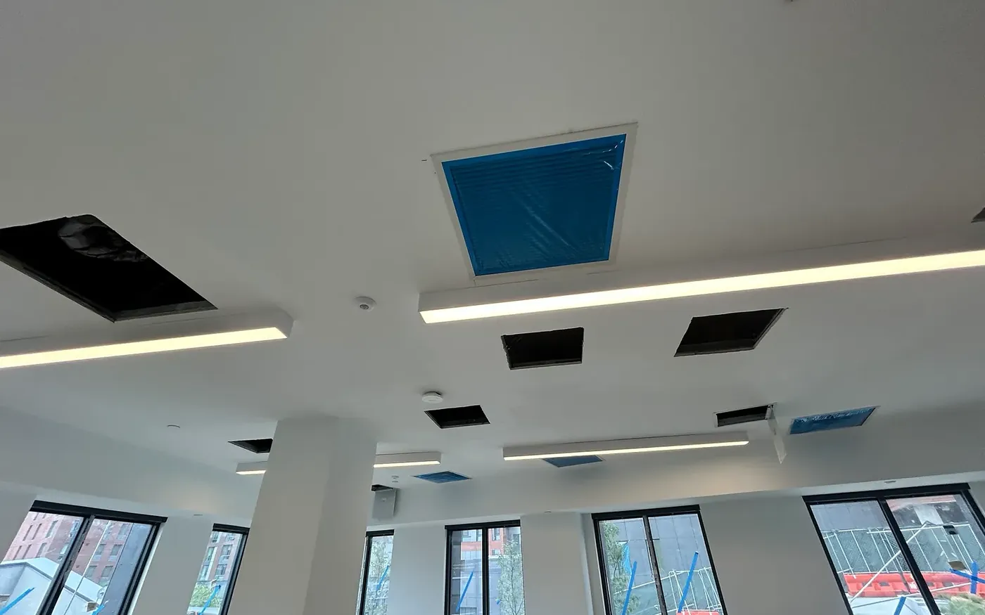 An open-plan commercial space with linear lighting